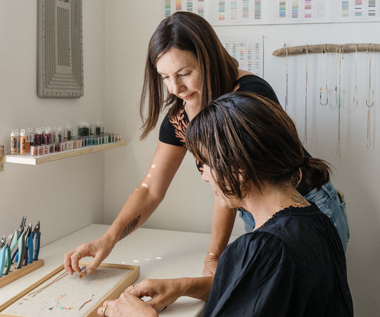 Seana and Misty working together on jewelry in the studio